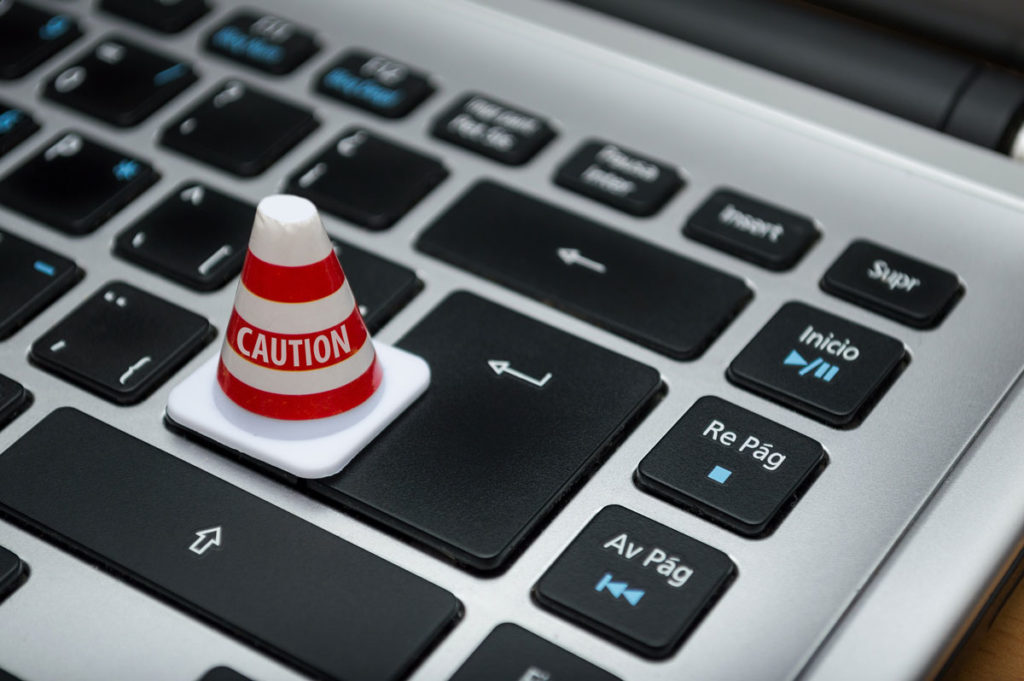 Tiny "caution" cone on a laptop keyboard