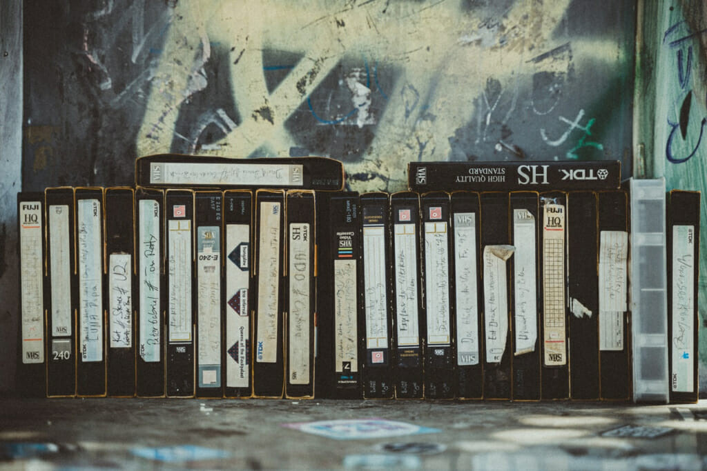 stack of VHS tapes with old home movies on them